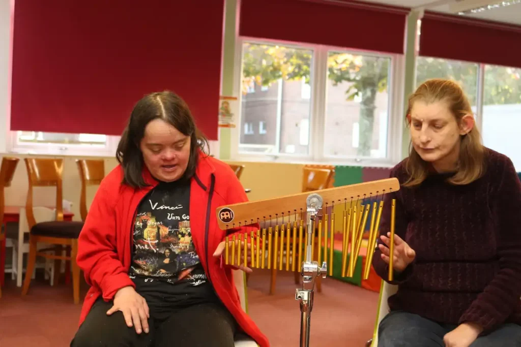 Young Adult enjoying Music Therapy at The Js Charity